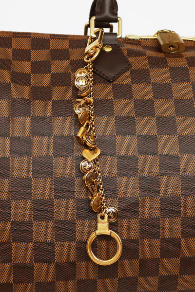 Louis Vuitton Gold Porte Cles Swing Tassel Bag Charm Golden Metal  ref.356503 - Joli Closet